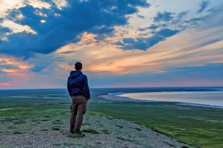 Male hiker looking at sunset