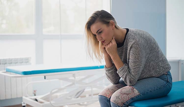 worried woman at hospital bed